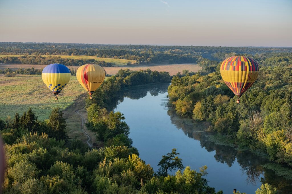 River landscape with hot air balloons