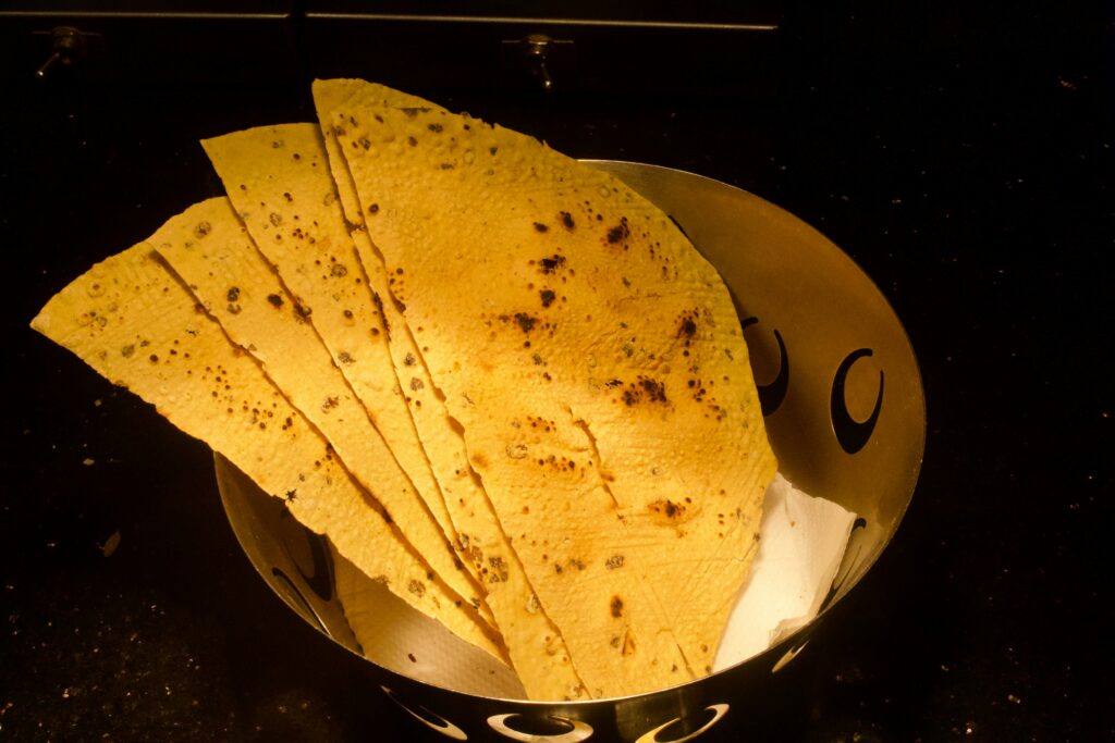 Corn tortillas warming in a pan