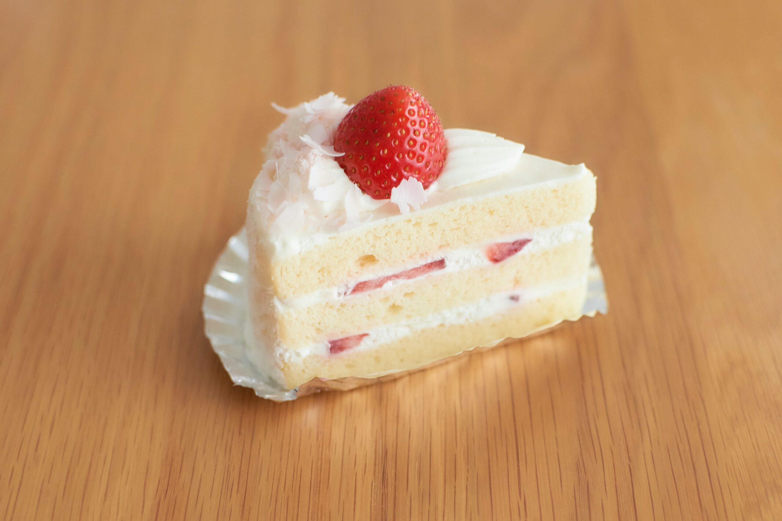Slice of cake with strawberry on top