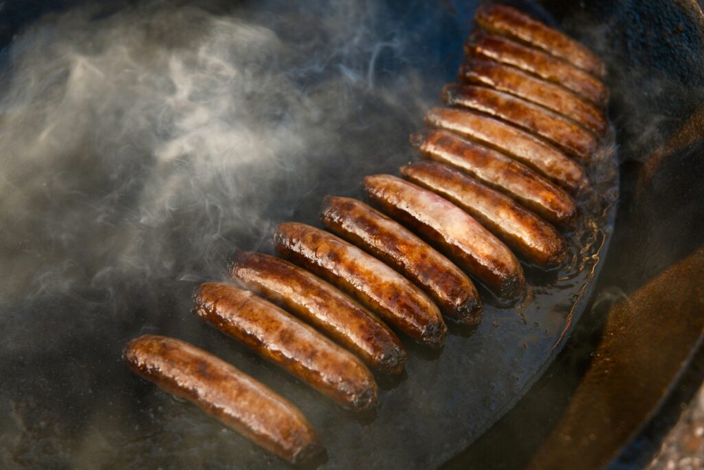 Sausages grilling with smoke