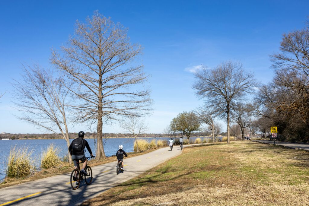 Cyclists riding along a park path