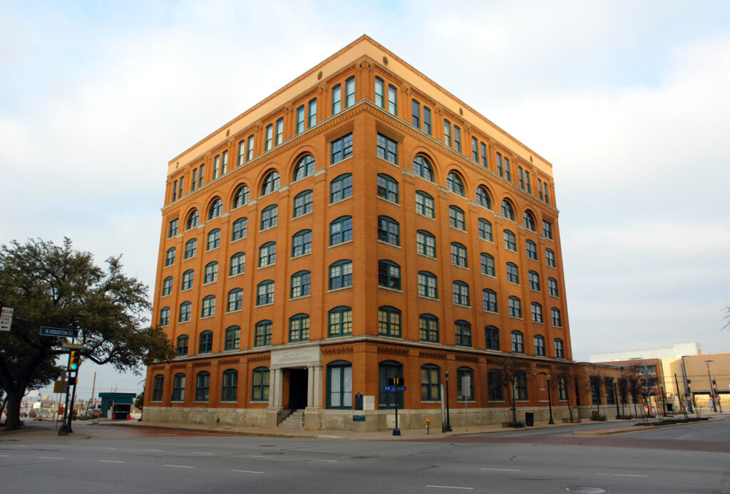 Corner view of a red brick commercial building with multiple floors